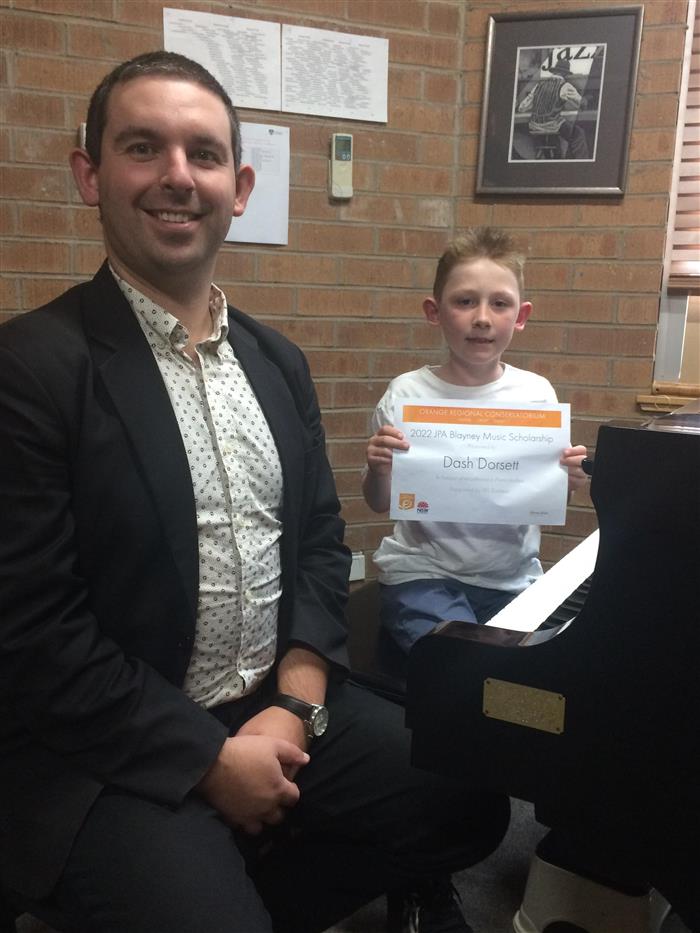 Dash Dorsett proudly displays his Scholarship Certificate with his Orange Regional Conservatorium music teacher David Shaw