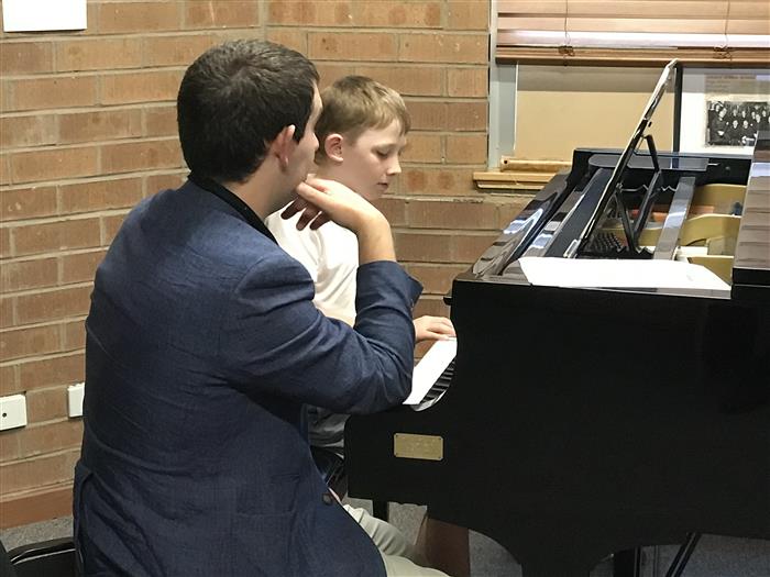 Dash Dorsett at a piano lesson with music teacher David Shaw.